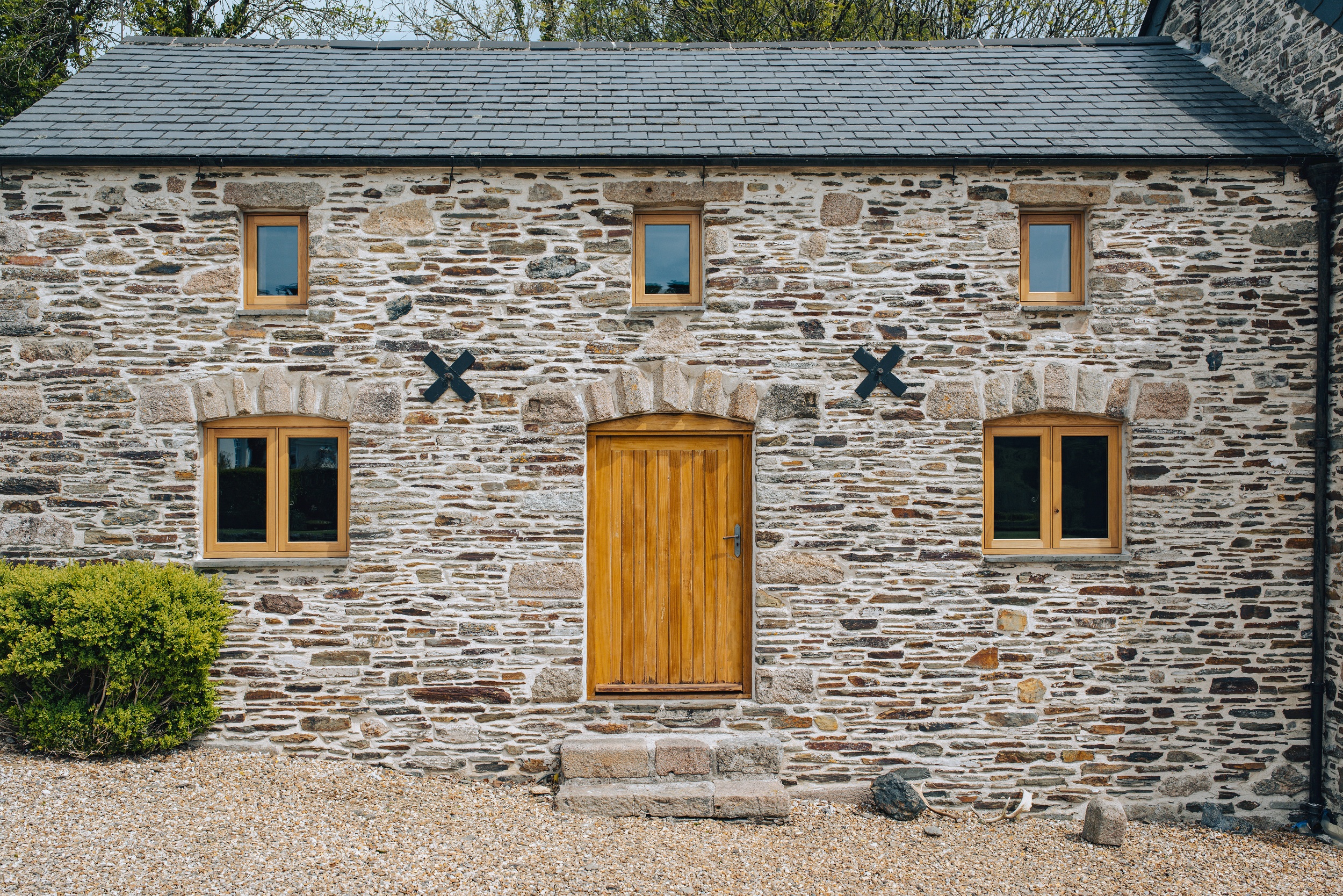 front view of barn conversion with bespoke timber doors and bespoke timber windows 