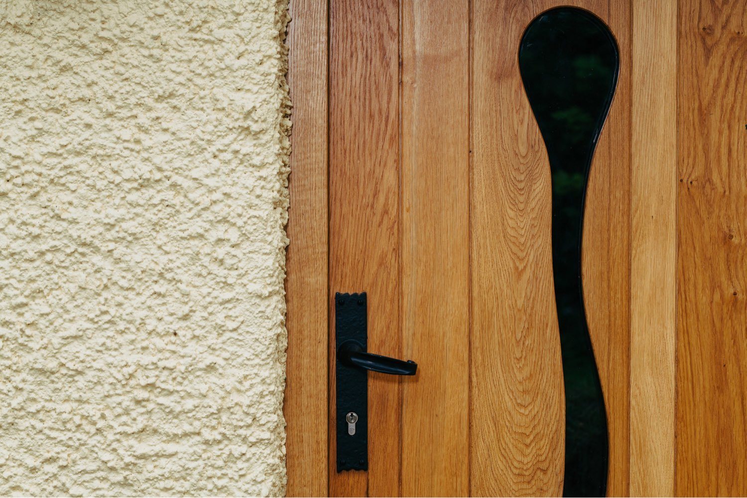 custom made wooden front door with wave glass